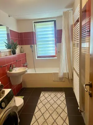 a bathroom with a tub and a sink and a toilet at Pegas Apartments in Prague