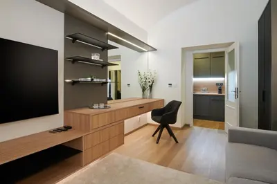 a living room with a desk and a television at PB apartment Prague in Prague