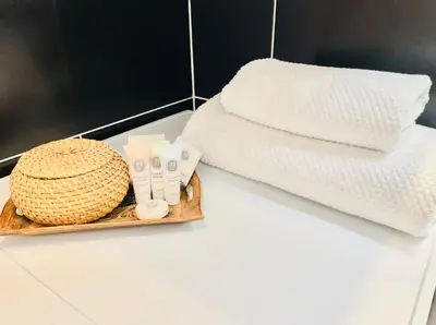 a tray with towels and a basket on a counter at PB apartment Prague in Prague