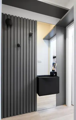 a room with a black wall with a mirror at PB apartment Prague in Prague