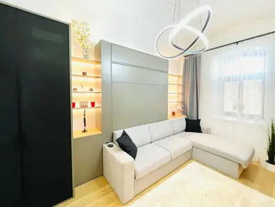a living room with a white couch and a chandelier at PB apartment Prague in Prague