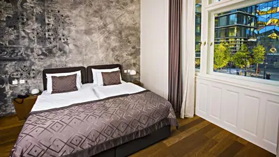 a bedroom with a bed and a window at Hotel Golden Crown in Prague