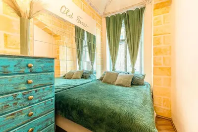a bedroom with a blue bed and a dresser at Wenceslas Palace Stay in Prague