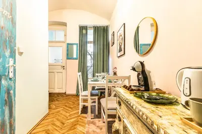 a kitchen and dining room with a table and chairs at Wenceslas Palace Stay in Prague