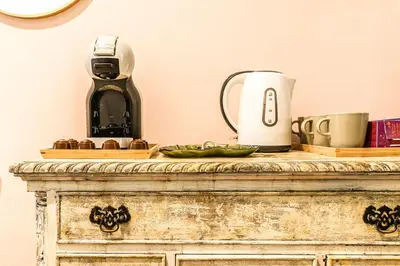 a table with a coffee maker on top of it at Wenceslas Palace Stay in Prague