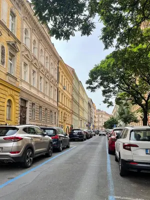 a street with cars parked on the side of the road at Wenceslas Palace Stay in Prague