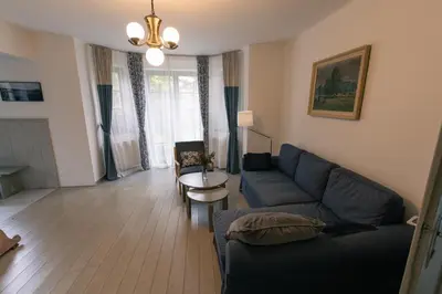 a bedroom with a bed with a wooden headboard at Vila Krocinka in Prague