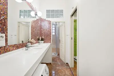 a bathroom with two sinks and a mirror at Prague Hostel Apartments in Prague