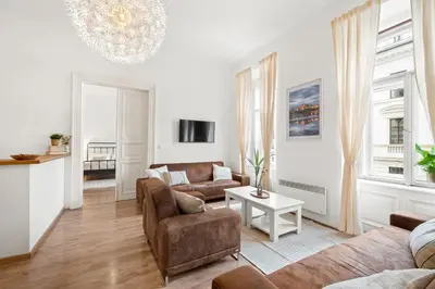 a living room with a couch and a table at Prague Hostel Apartments in Prague