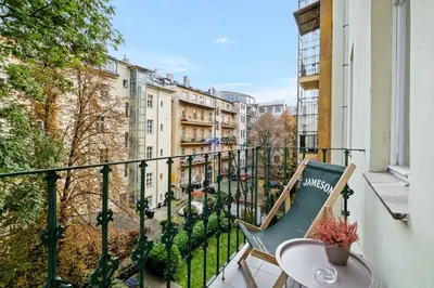 a balcony with a table and a chair on a balcony at Prague Hostel Apartments in Prague
