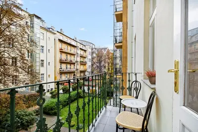 a balcony with tables and chairs and buildings at Prague Hostel Apartments in Prague