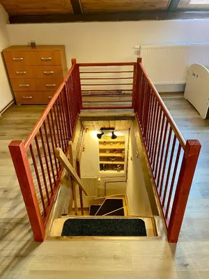 a room with a staircase with an oven in it at Chalupa Kokorinsko in Mšeno