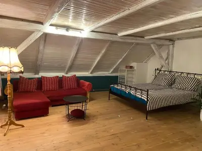 a living room with a couch and a bed at Chalupa Kokorinsko in Mšeno