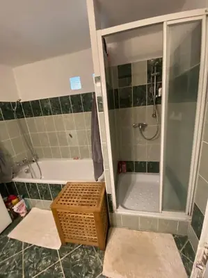 a bathroom with a shower with a glass door at Chalupa Kokorinsko in Mšeno