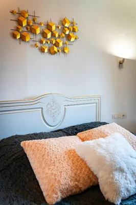 a bedroom with a bed with yellow books on the wall at River Deluxe Suite in Prague