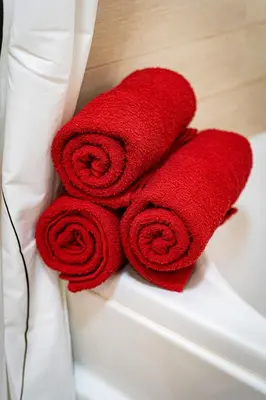 a pile of red towels sitting on a table at River Deluxe Suite in Prague