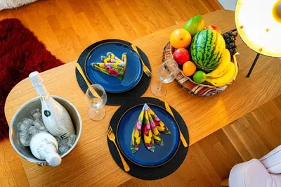 a table with plates of food and fruit on it at River Deluxe Suite in Prague