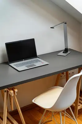 a laptop computer sitting on a desk with a chair at River Deluxe Suite in Prague