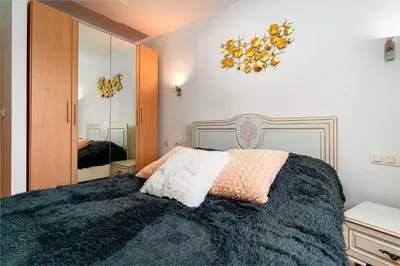 a bedroom with a large bed and a mirror at River Deluxe Suite in Prague