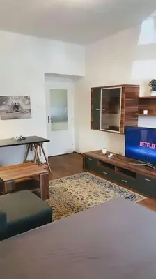 a living room with a couch and a tv at Prague Urban Retreat in Prague