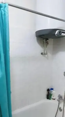 a bathroom with a blue shower curtain and a sink at Prague Urban Retreat in Prague
