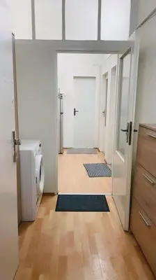 a bathroom with a door open to a room with a toilet at Prague Urban Retreat in Prague