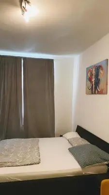 a bedroom with a bed with a window and a painting at Prague Urban Retreat in Prague