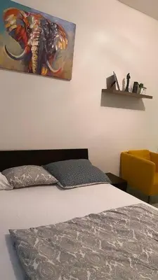 a bedroom with a bed and a painting on the wall at Prague Urban Retreat in Prague