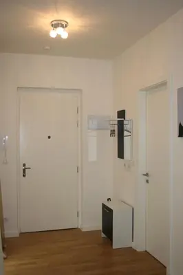 an empty room with a white door and a table at Apartment Marilyn in Prague