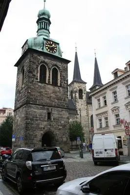 an old building with a clock tower on a street at Apartment Marilyn in Prague