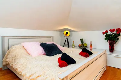 a bedroom with a bed with pillows on it at Golden River Apartment in Prague