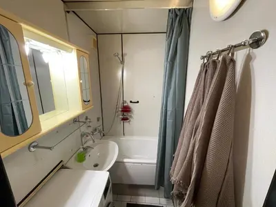 a bathroom with a tub and a sink and a shower at Apartmán Kamýk in Prague