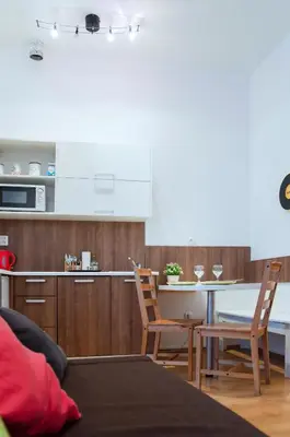 a kitchen and dining room with a table and chairs at Modern Apartments Opatovická in Prague