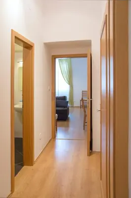 a living room with a door open to a living room at Modern Apartments Opatovická in Prague