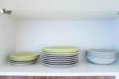 a group of plates sitting on a shelf at Modern Apartments Opatovická in Prague