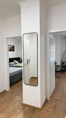 a mirror on a wall in a room with a bed at Modern apartment in Old town Prague in Prague