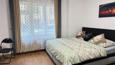 a bedroom with a bed and a large window at Modern apartment in Old town Prague in Prague