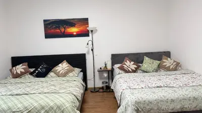 a room with two beds and a lamp at Modern apartment in Old town Prague in Prague