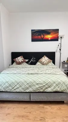 a bedroom with a bed with a picture on the wall at Modern apartment in Old town Prague in Prague