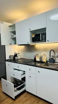 a kitchen with white cabinets and a microwave at Modern apartment in Old town Prague in Prague
