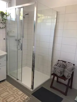 a shower with a glass door in a bathroom at Apartment s terasou Lysá in Lysá nad Labem