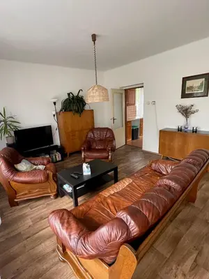 a living room with a couch and leather chairs at Apartment s terasou Lysá in Lysá nad Labem
