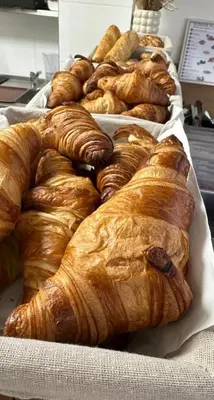a bunch of croissants and other breads on display at Hotel Karlova Prague in Prague
