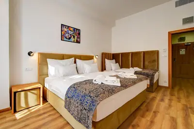 a hotel room with two beds with towels on them at Hotel Karlova Prague in Prague