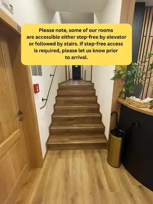 a stairway with a sign that reads process noise some of our rooms are accessible at Hotel Karlova Prague in Prague