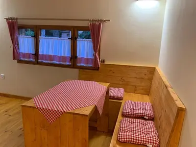 a room with a table and benches in a room at Chata Mareš in Samechov