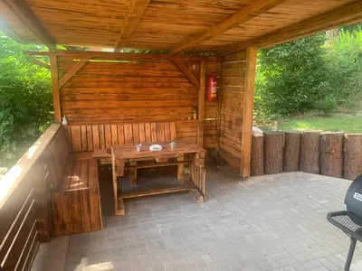 a wooden sauna with a wooden bench on a patio at Chata Mareš in Samechov