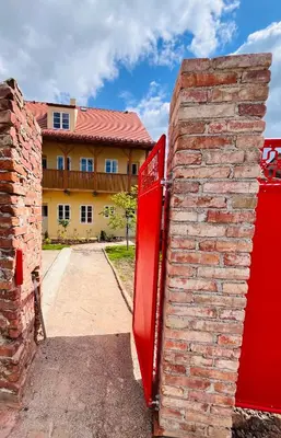a red mailbox is leaning against a brick wall at Četnická Stanice Mšeno in Mšeno