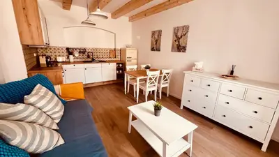 a living room with a blue couch and a kitchen at Četnická Stanice Mšeno in Mšeno
