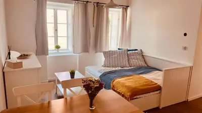 a small room with a bed and a table at Četnická Stanice Mšeno in Mšeno